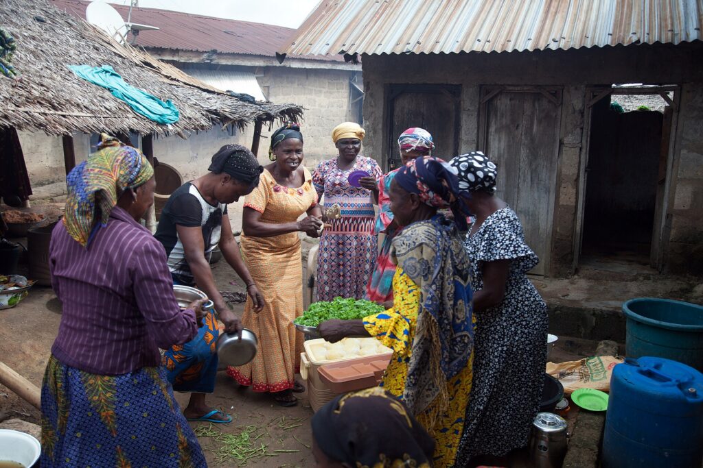 Women from a community in Ugep, Cross River State, preparing food together outdoors